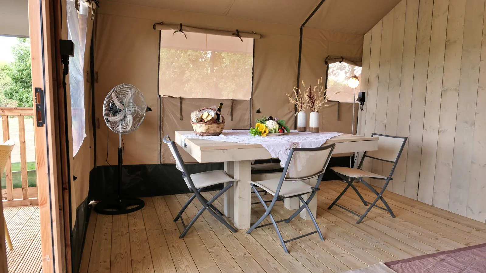 Il tavolo rotondo bianco e le sedute nella zona giorno del glamping