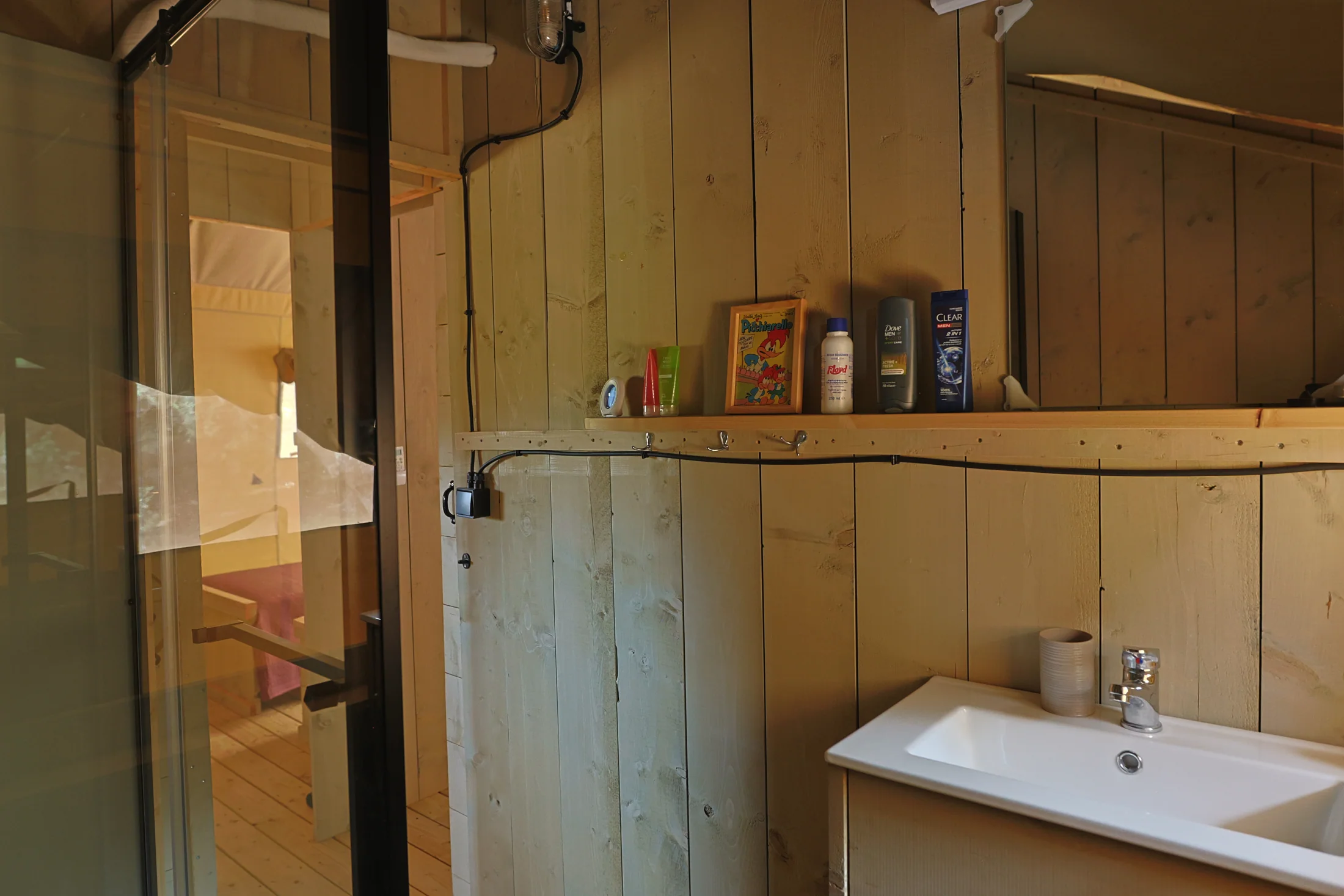 Il lavabo e lo specchio nel bagno interno del glamping